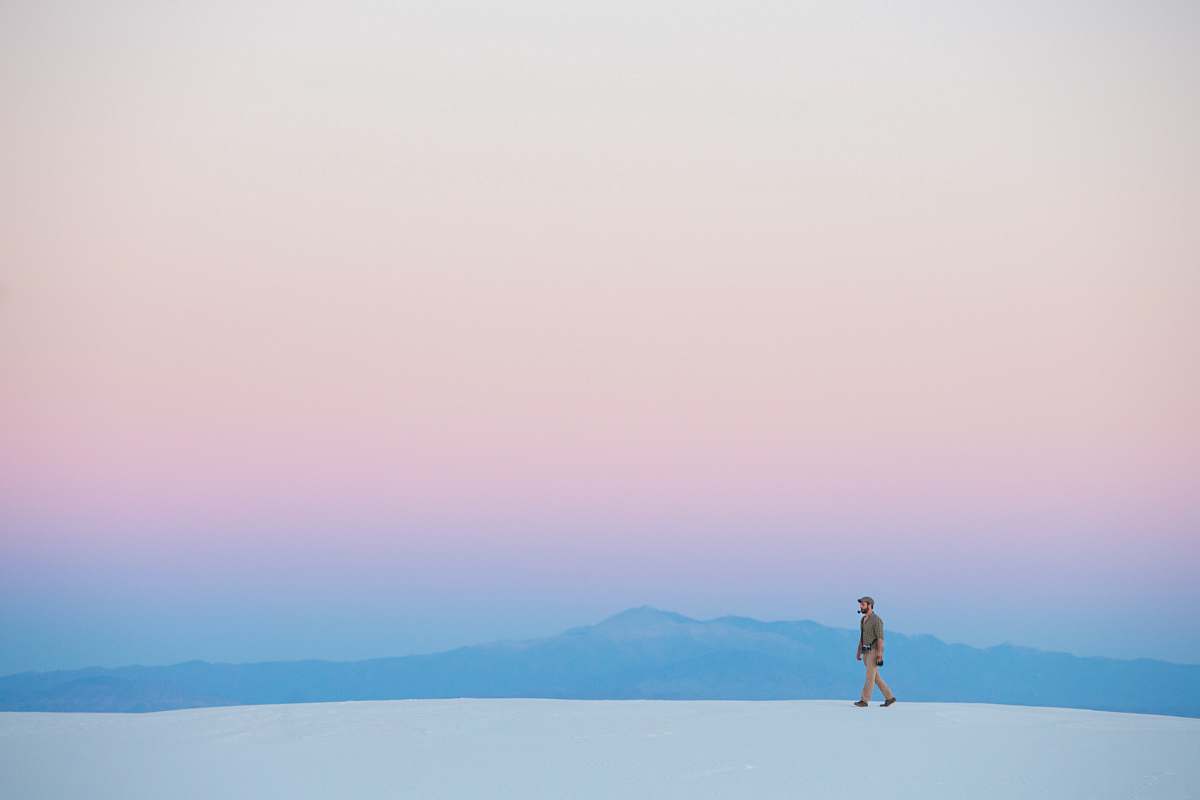 white sands human walking on snow covered mountain minimal